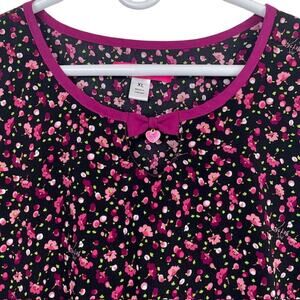Betsey Johnson women's scrub top in black with pink flowers.